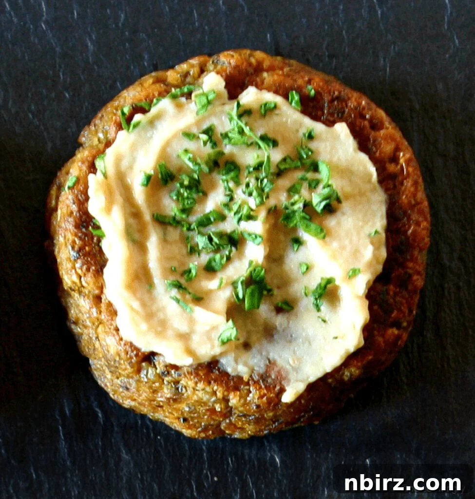 Effortless Oil Free Baked Falafel Vegan Gluten Free 4 baked oil-free falafel patty with a spread of hummus on top