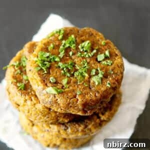 stack of baked oil-free falafel patties on white parchment paper