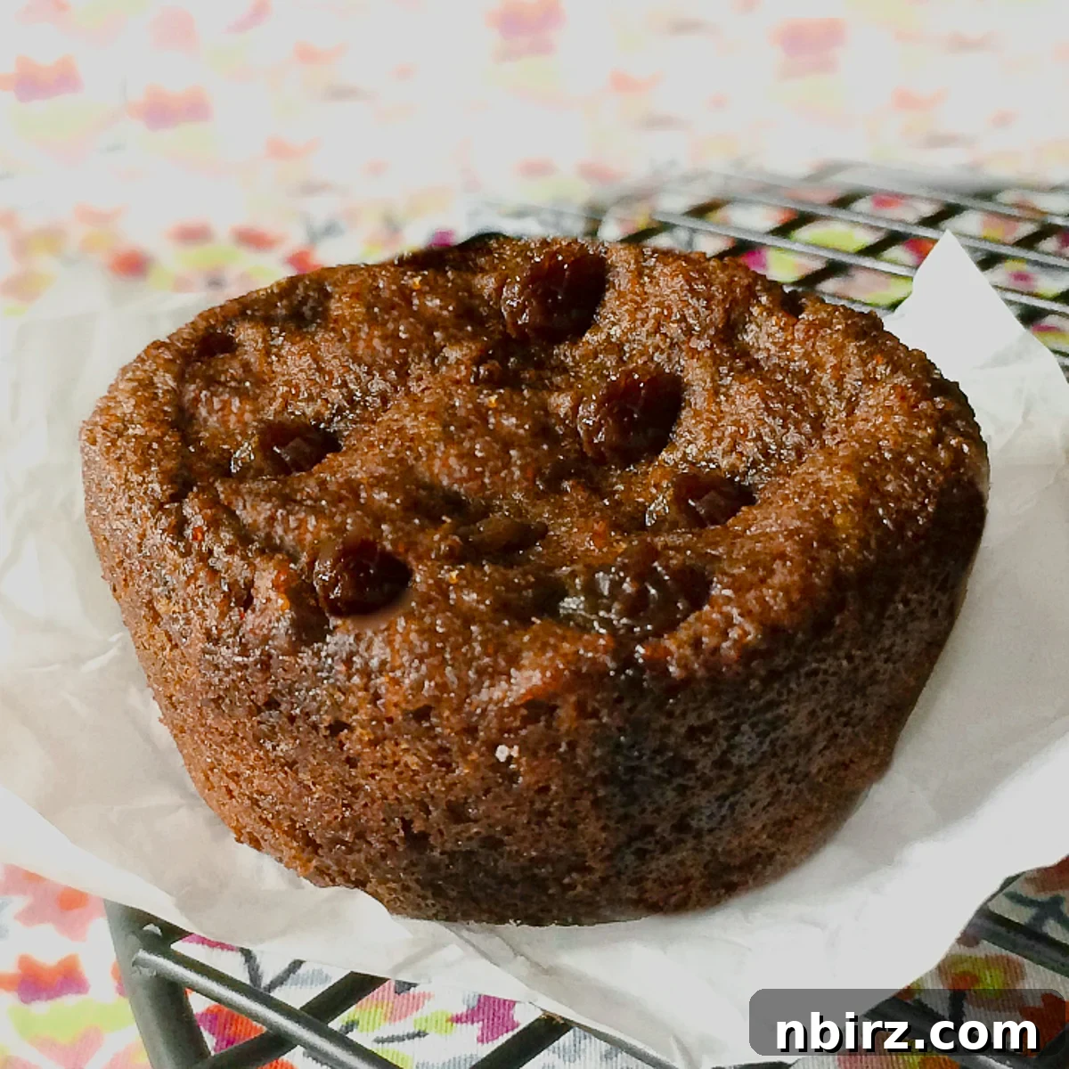Protein Packed Teff Raisin Loaf 3 high protein teff raisin bread on a piece of parchment paper