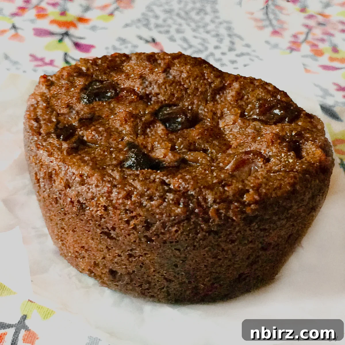 Protein Packed Teff Raisin Loaf 5 high protein teff bread on a piece of parchment paper