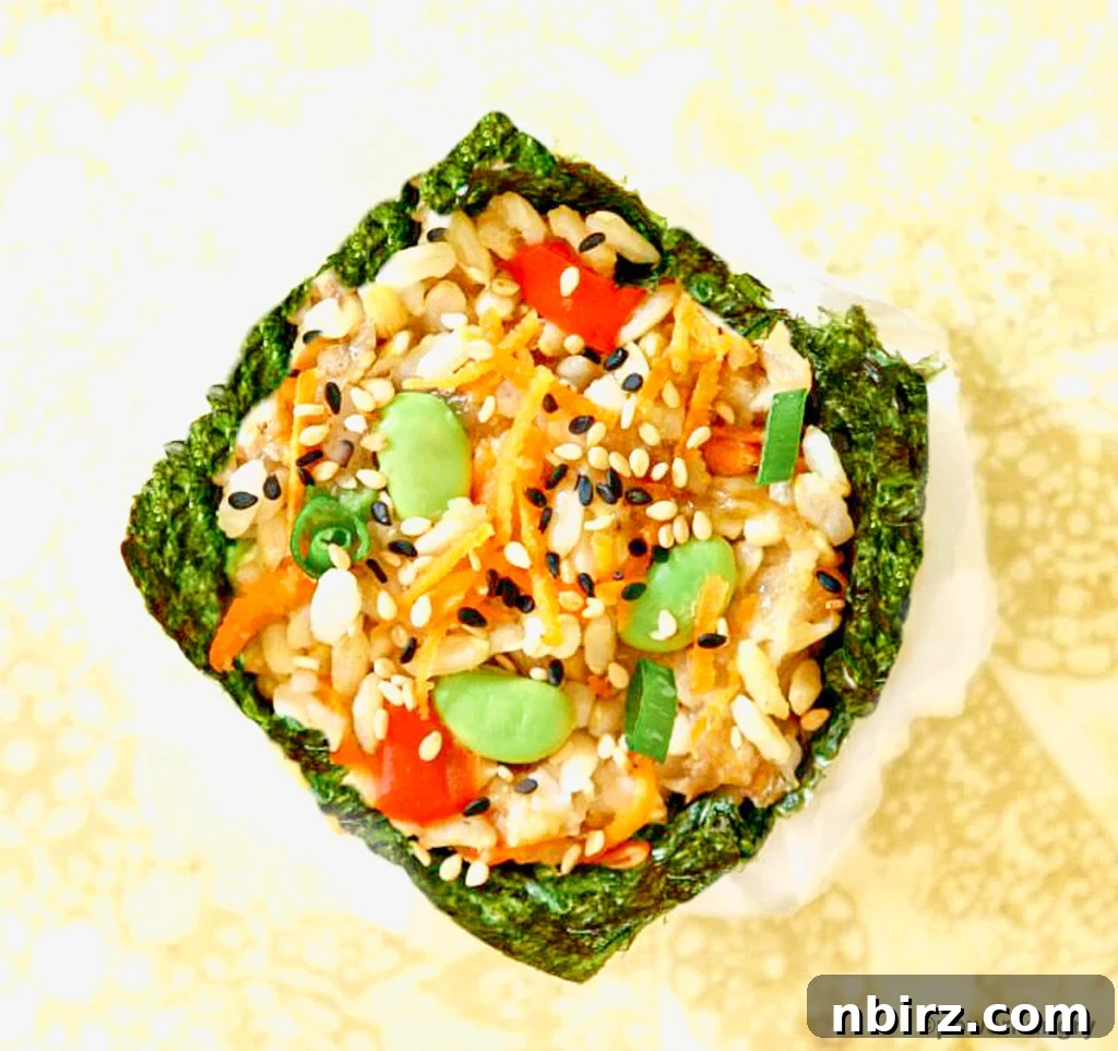 Effortless Plant-Based Gluten-Free Sushi Cups 3 An overhead shot showcasing several perfectly formed vegan muffin tin sushi pieces, garnished with sesame seeds.