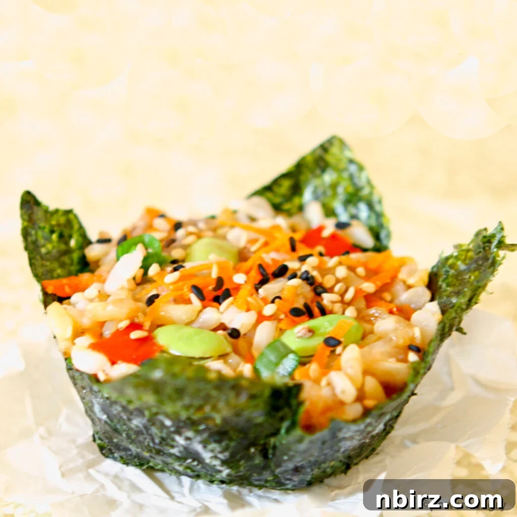 Effortless Plant-Based Gluten-Free Sushi Cups 5 Close-up of a single vegan muffin tin sushi piece on a beige napkin, showing the detailed texture of the rice and vegetables.