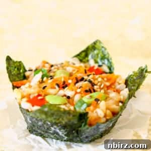 Effortless Plant-Based Gluten-Free Sushi Cups 6 Close-up of a single vegan muffin tin sushi piece on a beige napkin.