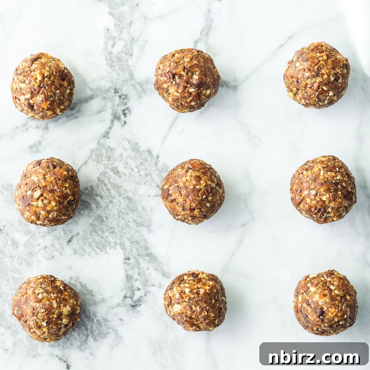 Simple Hemp Protein Power Bites 3 Hemp protein balls neatly arranged on a modern marble surface