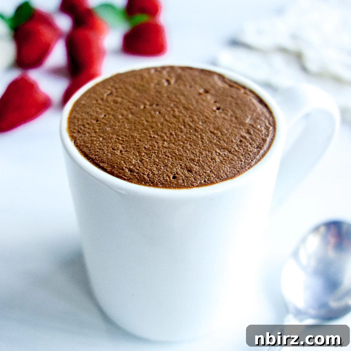 A close-up shot of the rich, dark vegan chocolate protein mousse in small white ramekins.