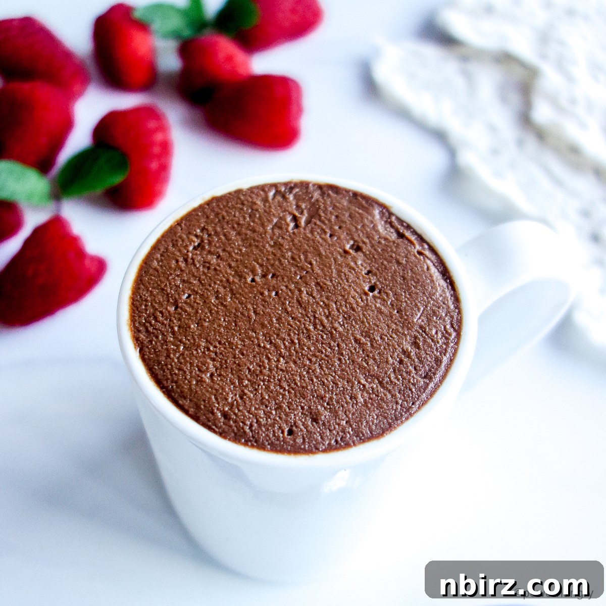 A single serving of vegan chocolate mousse in a white cup, ready to be enjoyed.