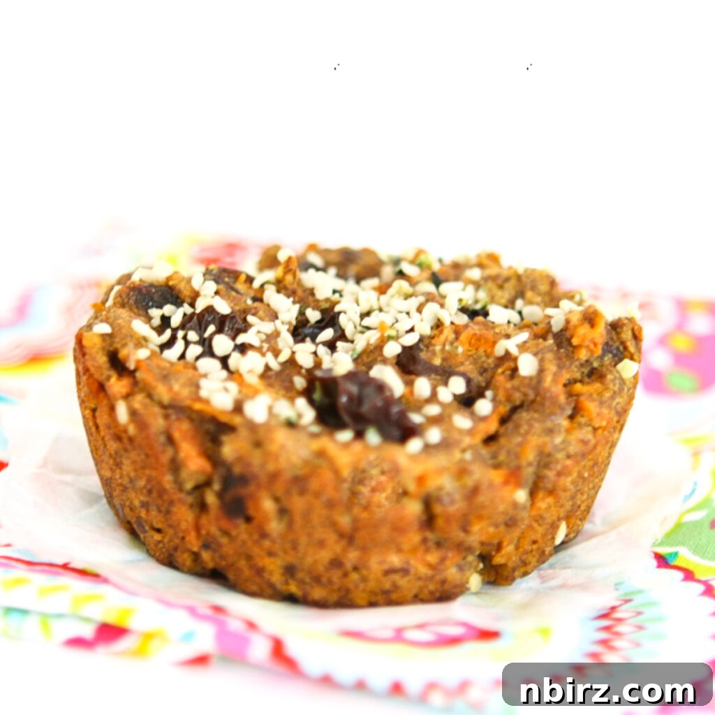 Delightful Vegan Carrot Cake Breakfast Cookies Gluten Free Oil Free 4 A single vegan carrot cake breakfast cookie resting on a colorful napkin, showing its appealing texture