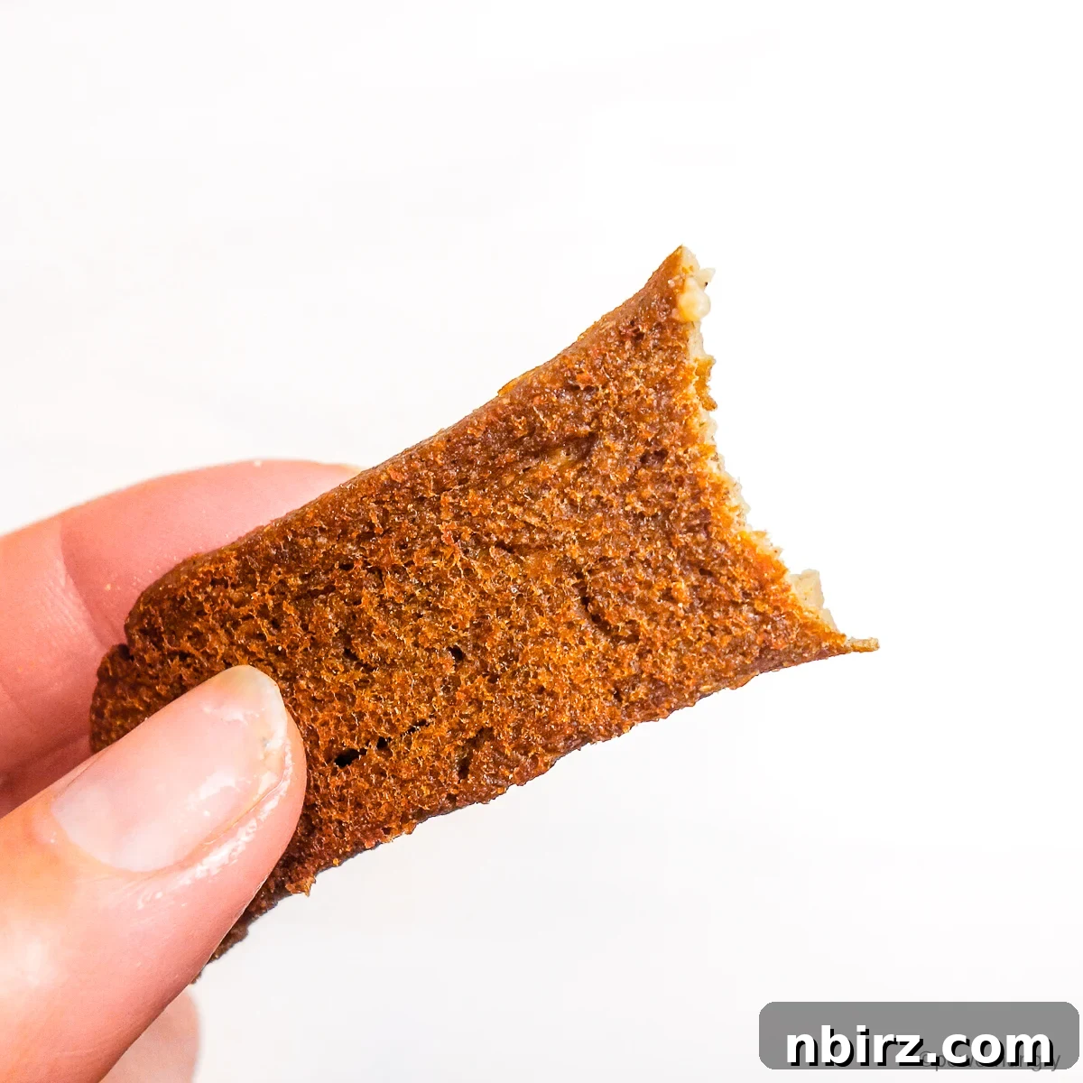Power-Packed Lentil Gyros Soy-Free Goodness 5 A hand holding a perfectly cooked strip of lentil gyro, ready to be enjoyed.