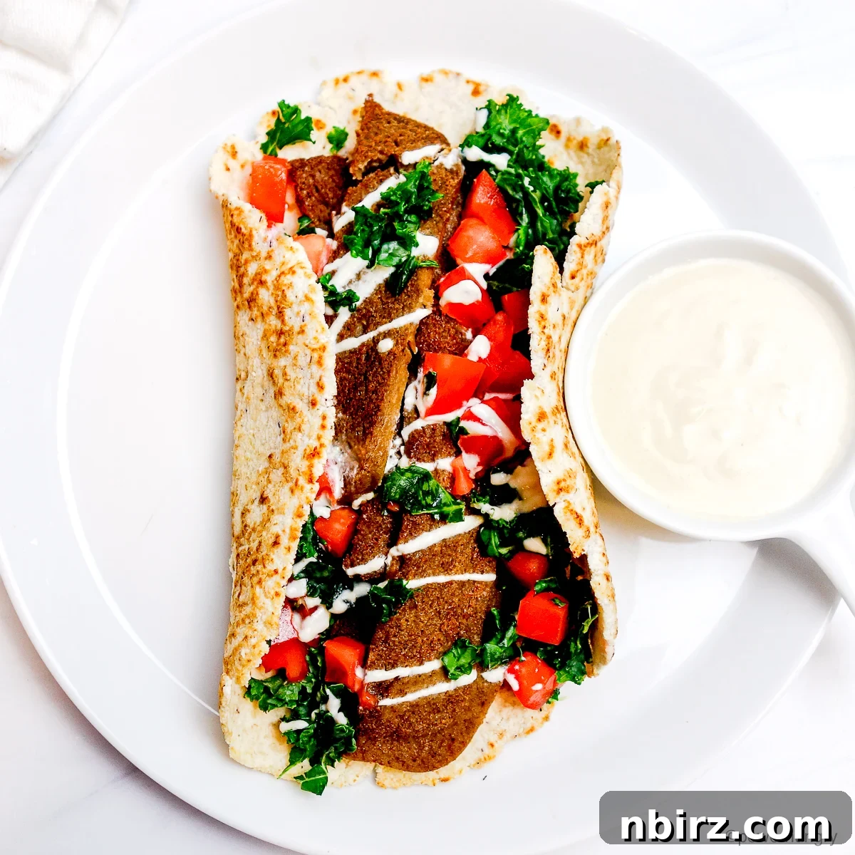 Power-Packed Lentil Gyros Soy-Free Goodness 6 An overhead shot of a vibrant platter of lentil gyros with fresh toppings, ready to be served.