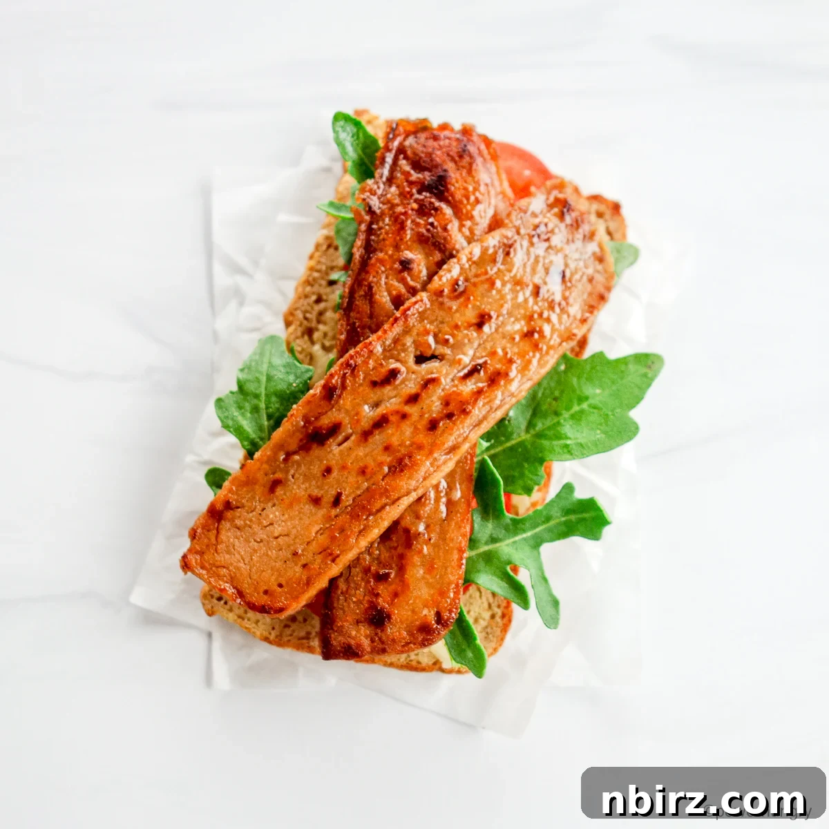 Crispy Soy-Free Lentil Bacon 6 A hearty lentil bacon sandwich, brimming with fresh ingredients and plant-based goodness.