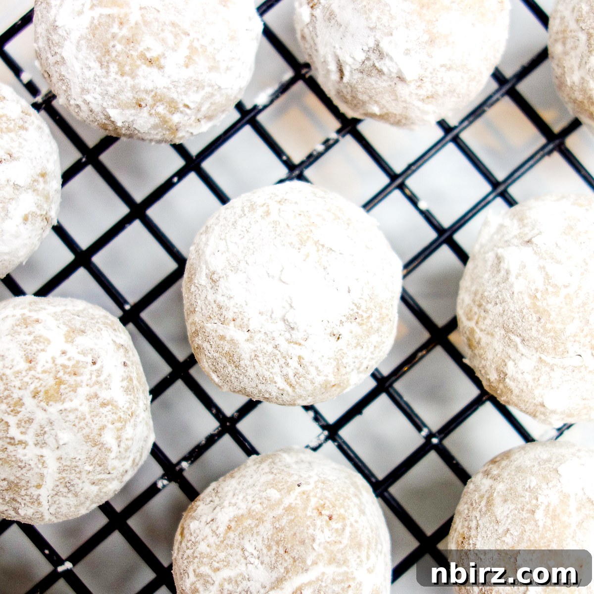 The Perfect Grain-Free Vegan Wedding Cookie 7 Coconut flour wedding cookies on black cooling rack
