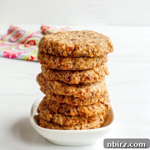 Stack of freshly baked 2-ingredient coconut date cookies.