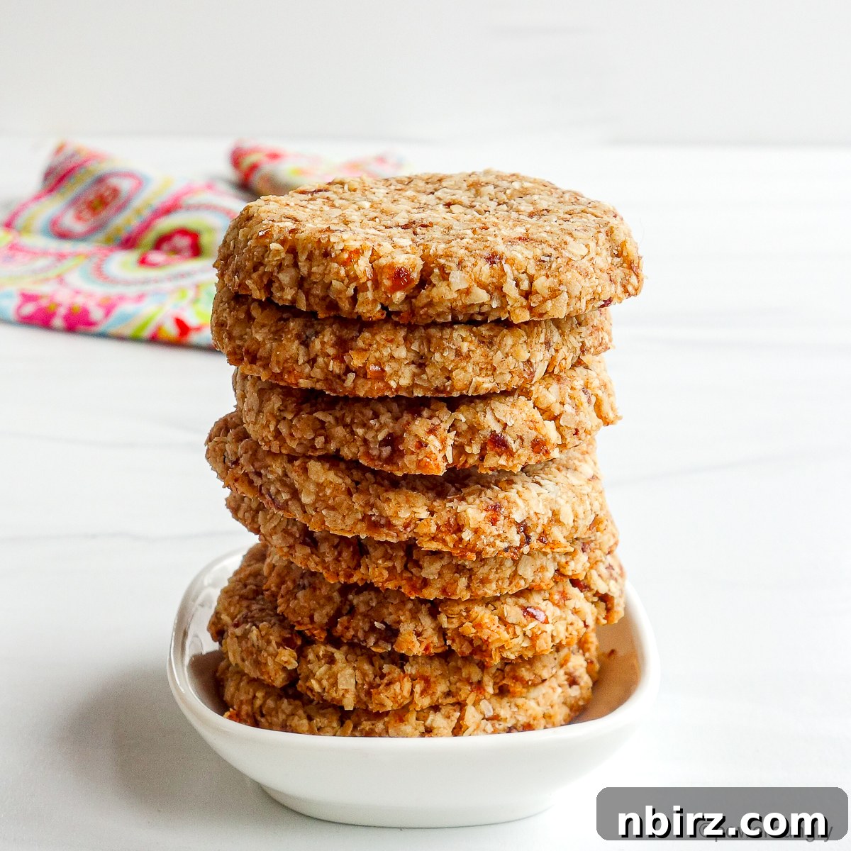 Wholesome Two-Ingredient Coconut Date Bites 9 A stack of perfectly baked 2-ingredient coconut date cookies.