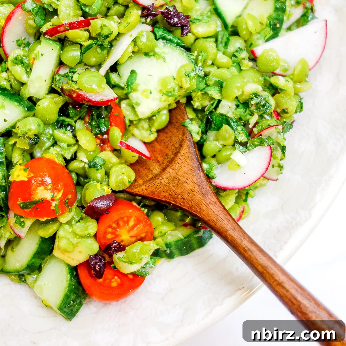 Protein Rich Oil Free Split Pea Salad 3 Close-up shot of the refreshing split pea salad, showcasing its vibrant ingredients and inviting texture in a white bowl.