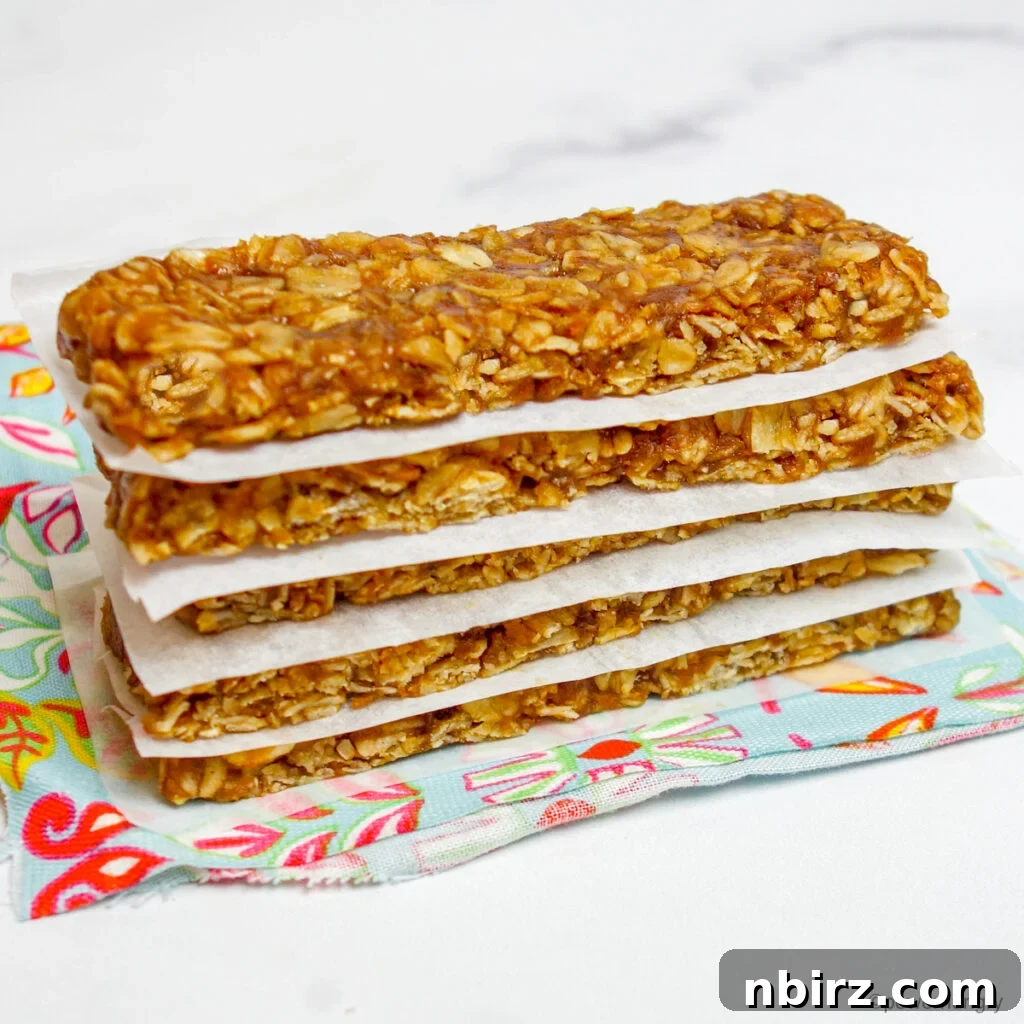 Stack of 3-ingredient no-bake granola bars on a colorful napkin