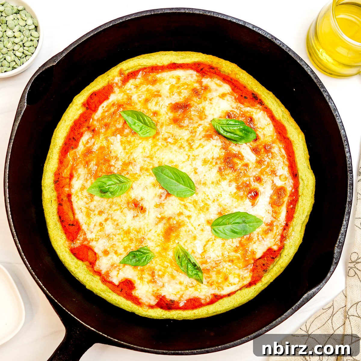 Quick Protein Packed Split Pea Pizza Crust 2 Delicious high-protein split pea pizza crust in a cast iron skillet, topped with fresh ingredients