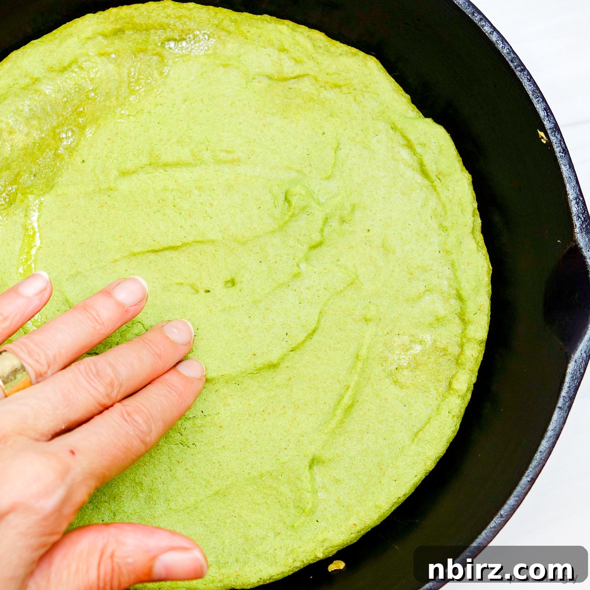 Quick Protein Packed Split Pea Pizza Crust 7 Split pea pizza crust in a cast iron skillet after its first bake, looking golden and firm