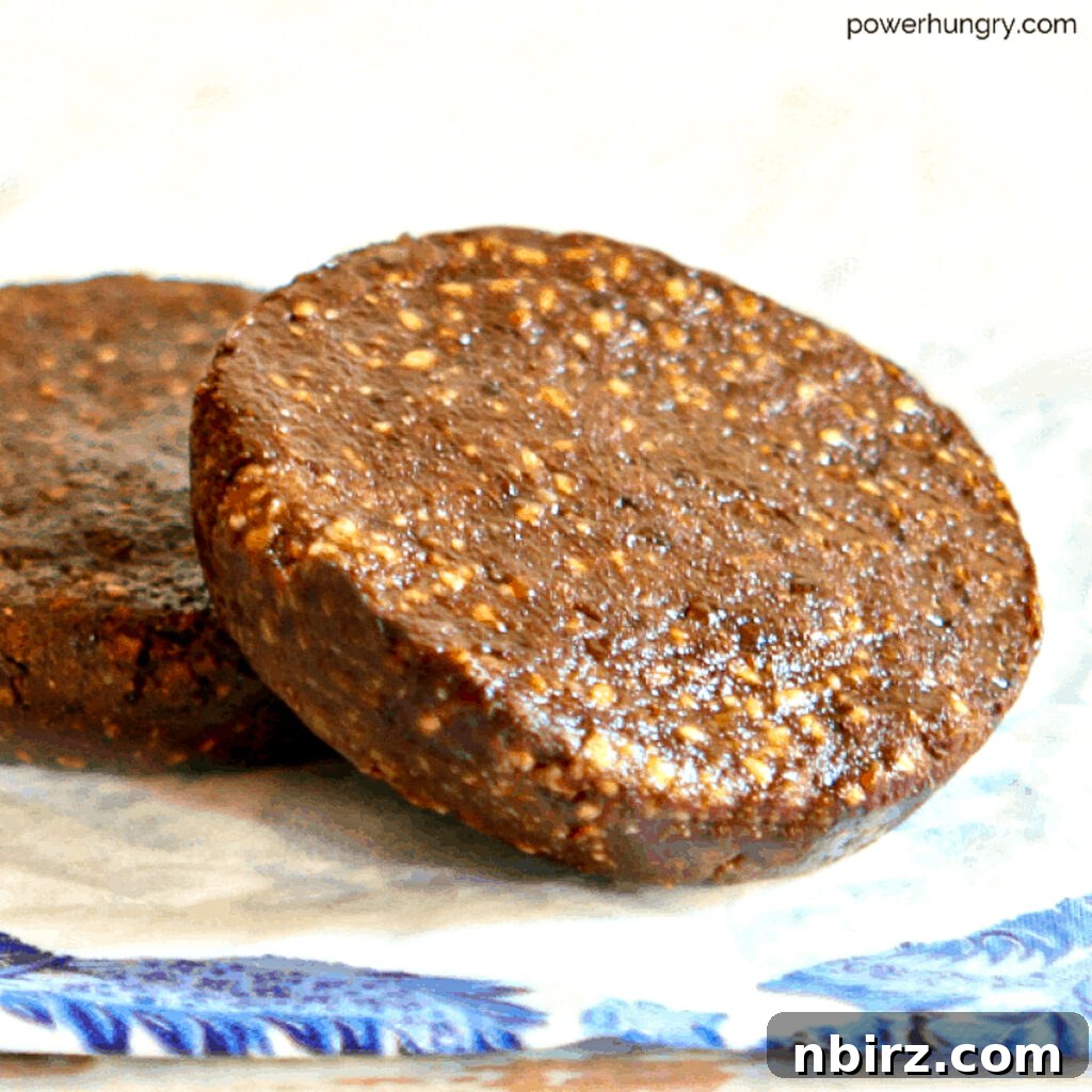 Two perfectly formed no-bake chocolate sunflower seed bars, stacked artfully, ready to be enjoyed.