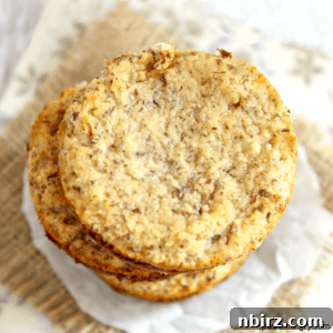 Savory Vegan Grain Free Cauliflower Coconut Biscuits 2 coconut flour cauliflower bread stacked on a piece of parchment paper