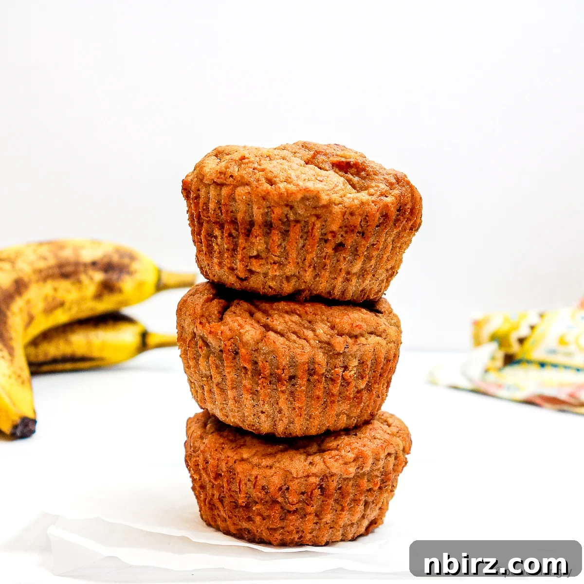 Wholesome Four Ingredient Banana Cassava Muffins 2 stack of three cassava flour banana muffins, perfectly golden brown and inviting