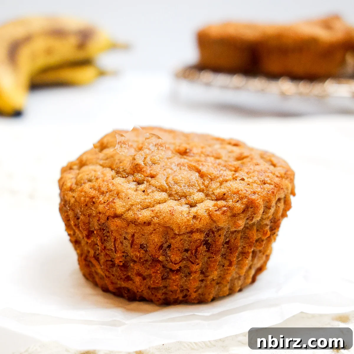 Wholesome Four Ingredient Banana Cassava Muffins 10 a single cassava flour banana muffin with a beautiful golden top