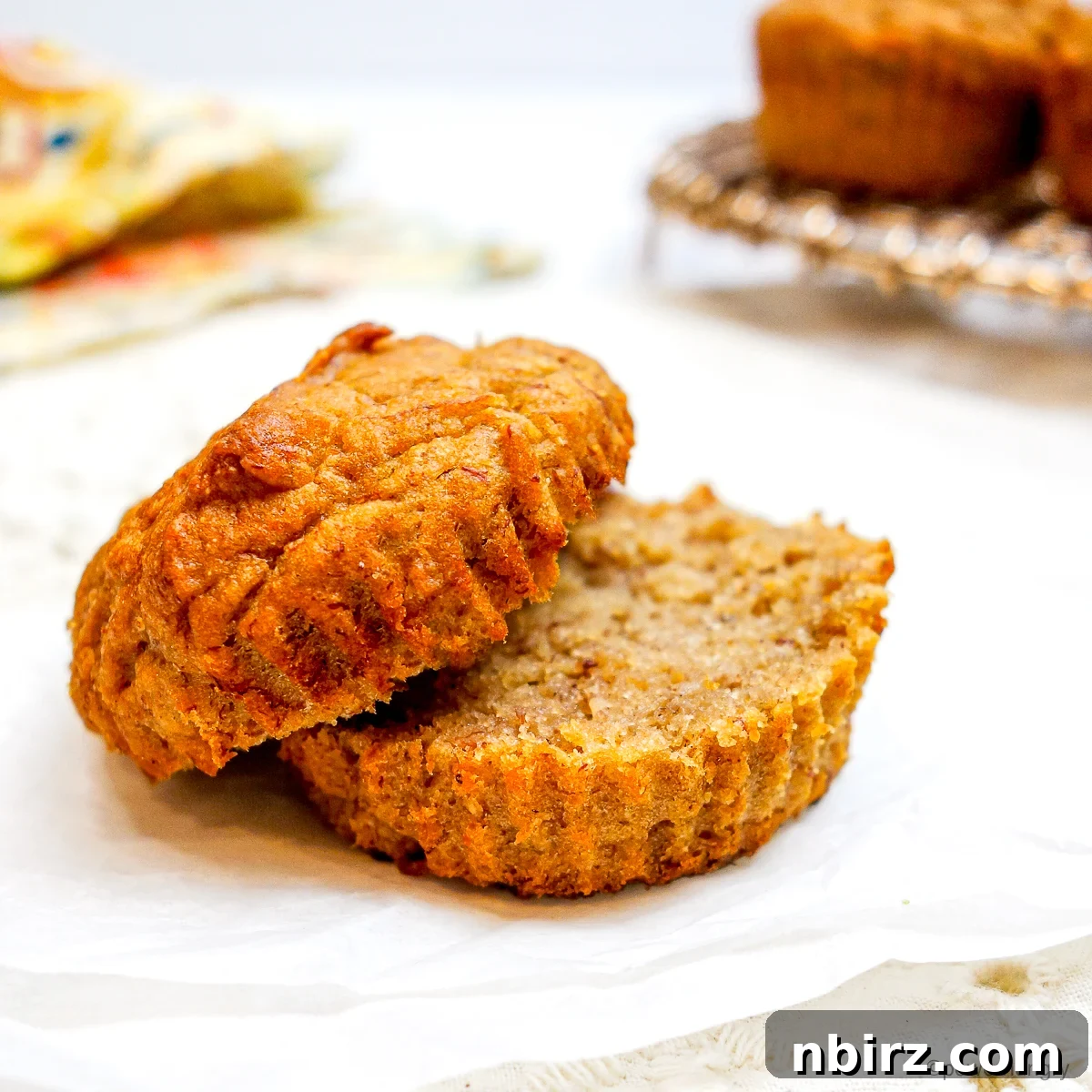 Wholesome Four Ingredient Banana Cassava Muffins 3 a single cassava flour banana muffin sliced in half, showing its fluffy texture