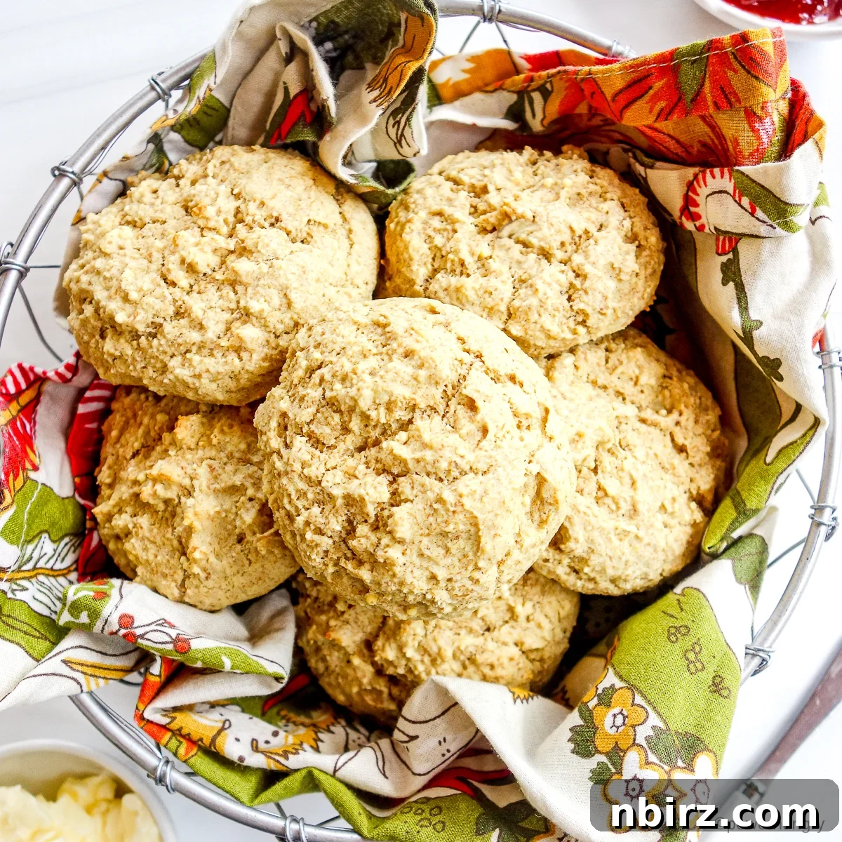 Effortless 4-Ingredient Millet Biscuits: Gluten-Free & Vegan Delight 2 Golden millet biscuits in a rustic basket, perfect for a healthy and tasty snack.