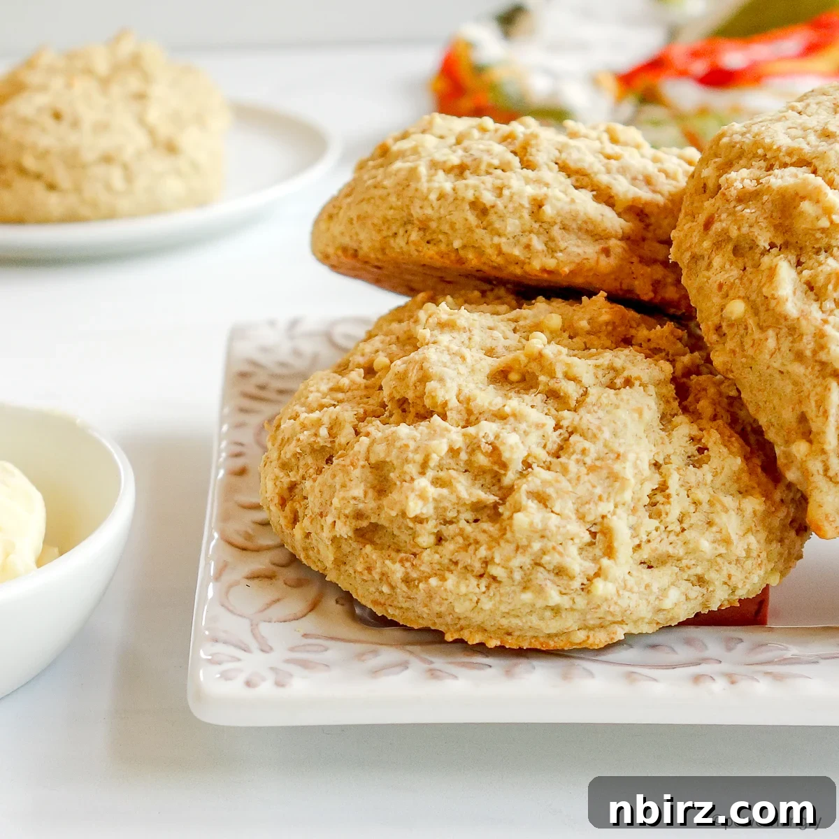 Effortless 4-Ingredient Millet Biscuits: Gluten-Free & Vegan Delight 3 Close-up of fluffy millet biscuits on a white plate, showcasing their light and airy texture.