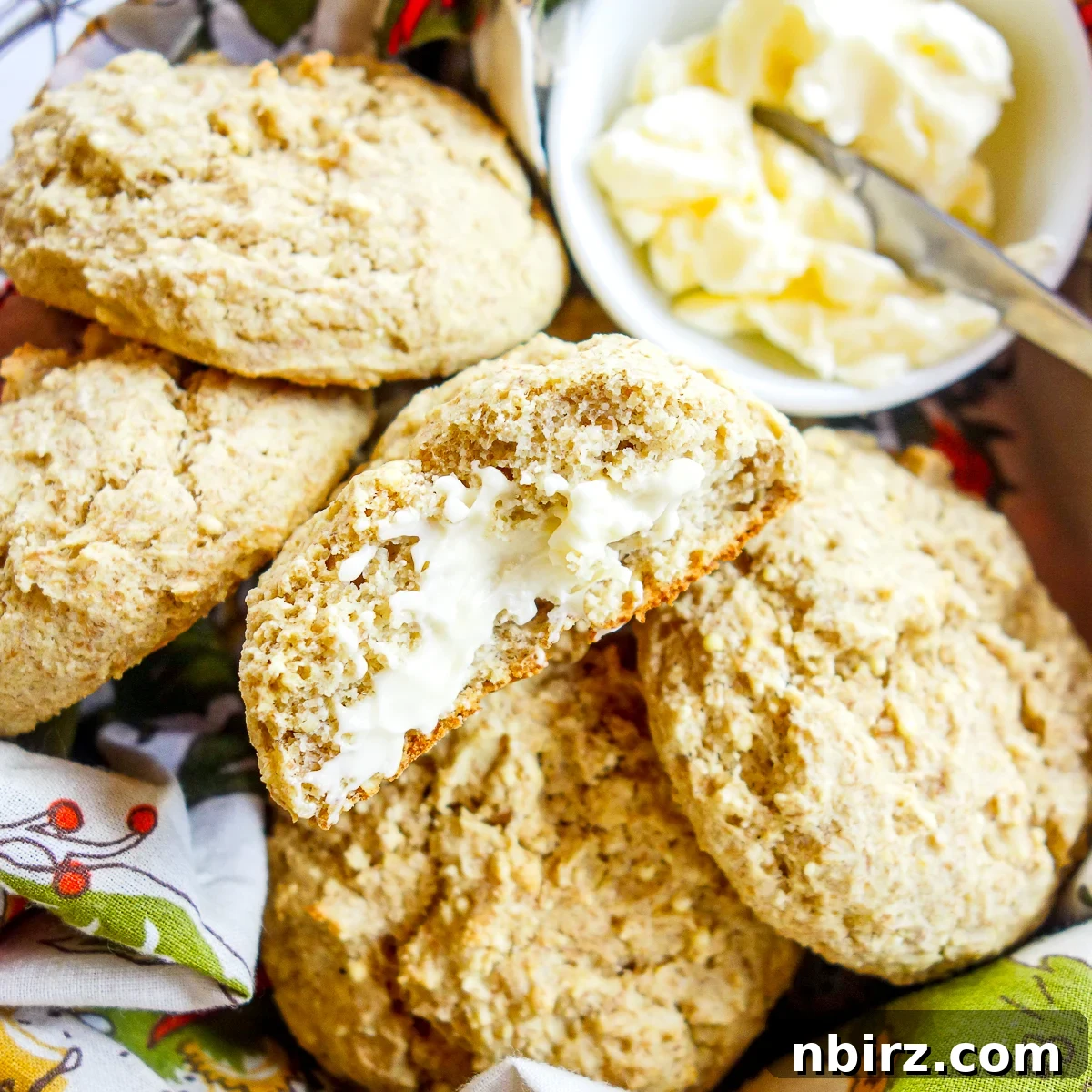 Effortless 4-Ingredient Millet Biscuits: Gluten-Free & Vegan Delight 9 A basket brimming with warm millet biscuits, one spread with vegan butter, inviting you to indulge.
