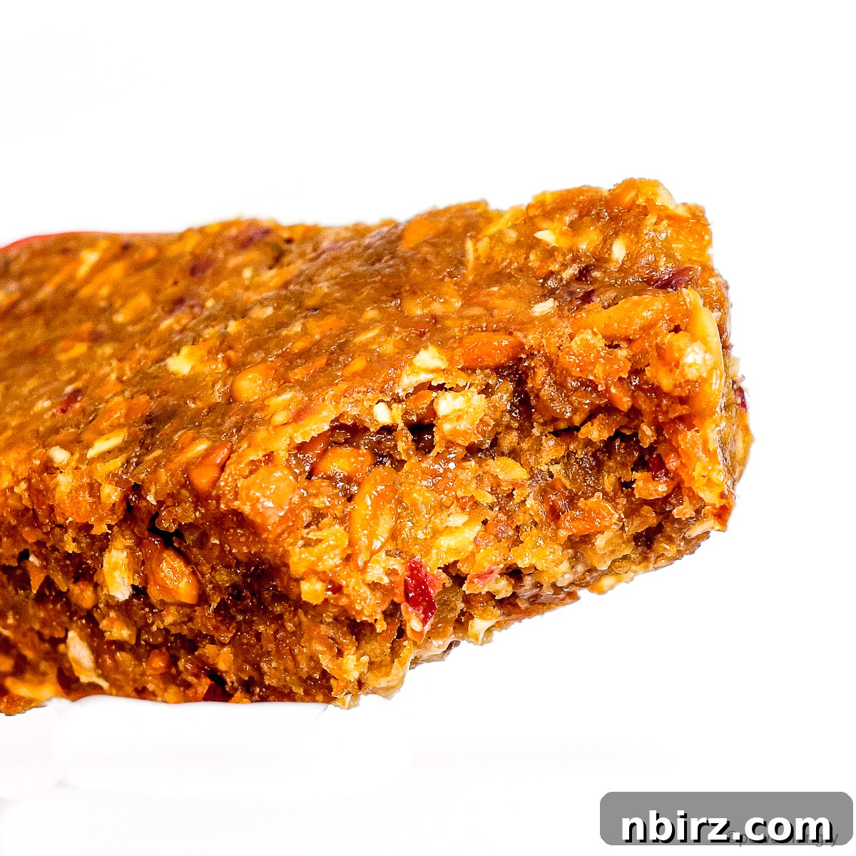 A close-up shot of a single high protein flax bar, revealing its wholesome texture and ingredients, ready to be enjoyed.
