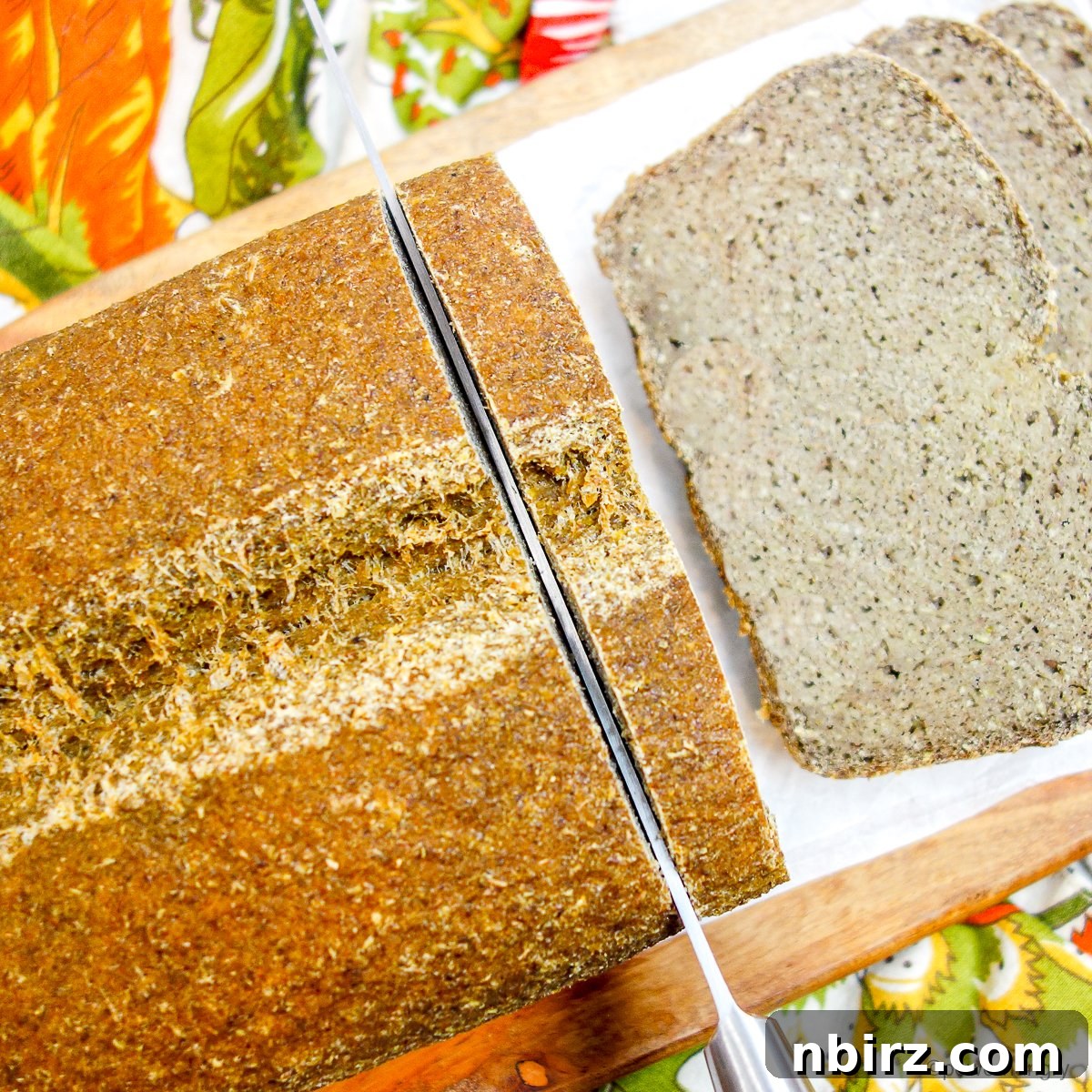 Protein-Packed Four-Ingredient Tofu Lentil Loaf 4 A loaf of tofu lentil bread being expertly sliced on a wooden cutting board
