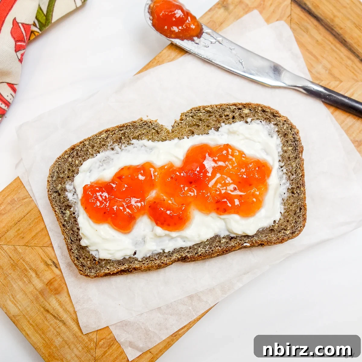 Protein-Packed Four-Ingredient Tofu Lentil Loaf 5 A slice of lentil tofu protein bread topped with vegan cream cheese and jam