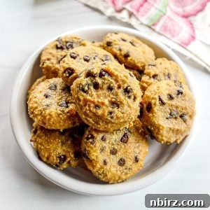 Deliciously Vegan Gluten-Free Almond Protein Cookies 12 White plate filled with almond flour protein cookies, ready to be served.
