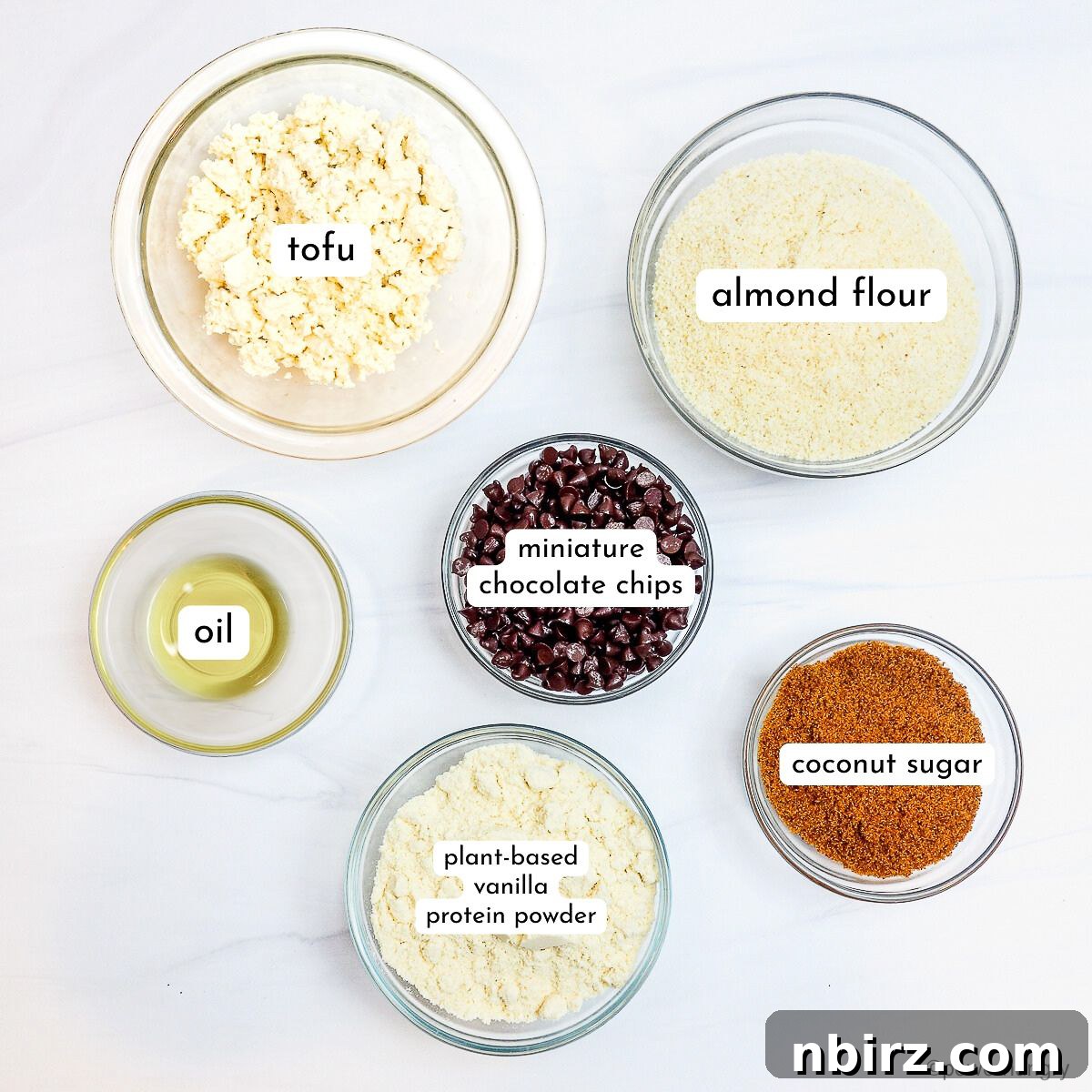 Deliciously Vegan Gluten-Free Almond Protein Cookies 4 Glass bowls containing the various ingredients for almond flour protein cookies.