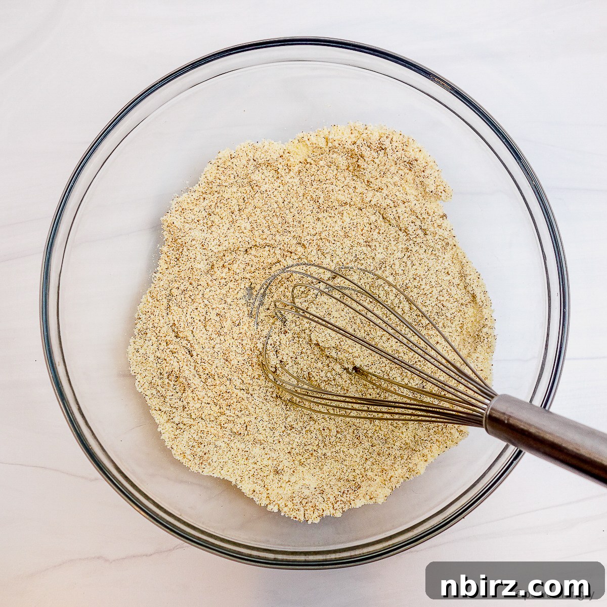 Deliciously Vegan Gluten-Free Almond Protein Cookies 5 Glass bowl filled with whisked dry ingredients for cookies.