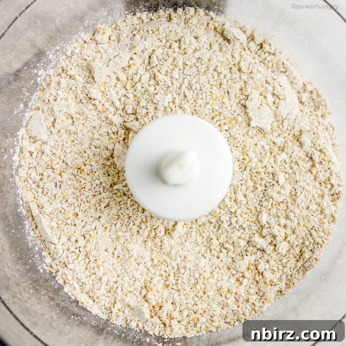 Healthy Oil Free Gluten Free Applesauce Oatmeal Bread 3 Rolled oats being ground into a fine flour in a food processor