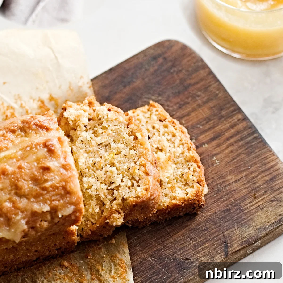 Healthy Oil Free Gluten Free Applesauce Oatmeal Bread 5 Perfectly sliced applesauce oat bread on a wooden cutting board