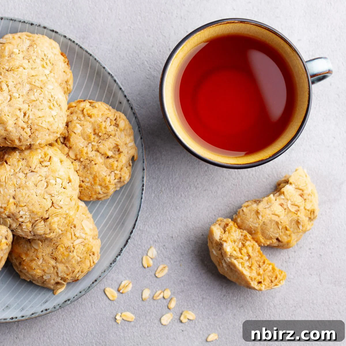 No-Fuss Almond Butter Oat Cookies 6 A plate of almond oat flour cookies with a cup of steaming tea alongside, ready to be enjoyed