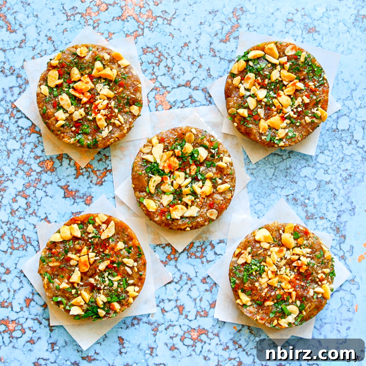 Umami Thai Protein Power Bites 3 Overhead view of several homemade savory Thai protein bars, showing the crushed peanut topping.