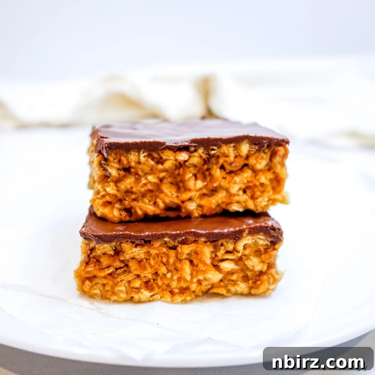 TVP Protein Crispy Bites Grain Free Oil Free 2 Two stacked TVP protein crispy treats, showcasing their appealing texture and chocolate topping.