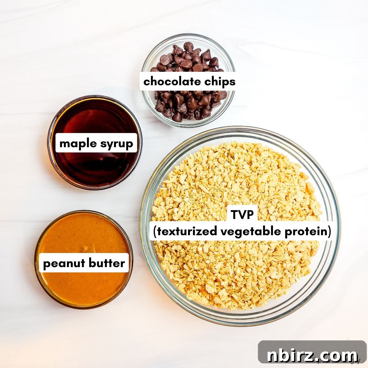 TVP Protein Crispy Bites Grain Free Oil Free 4 An array of ingredients for TVP bars artfully arranged in glass bowls on a white background.