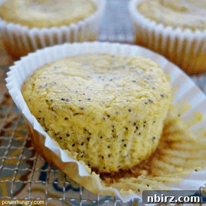 Sunshine-Kissed Grain-Free Vegan Lemon Poppy Seed Muffins 2 A vibrant close-up of a freshly baked lemon poppy seed muffin, highlighting its golden crust and crumbly texture. This image represents the final product of the recipe.