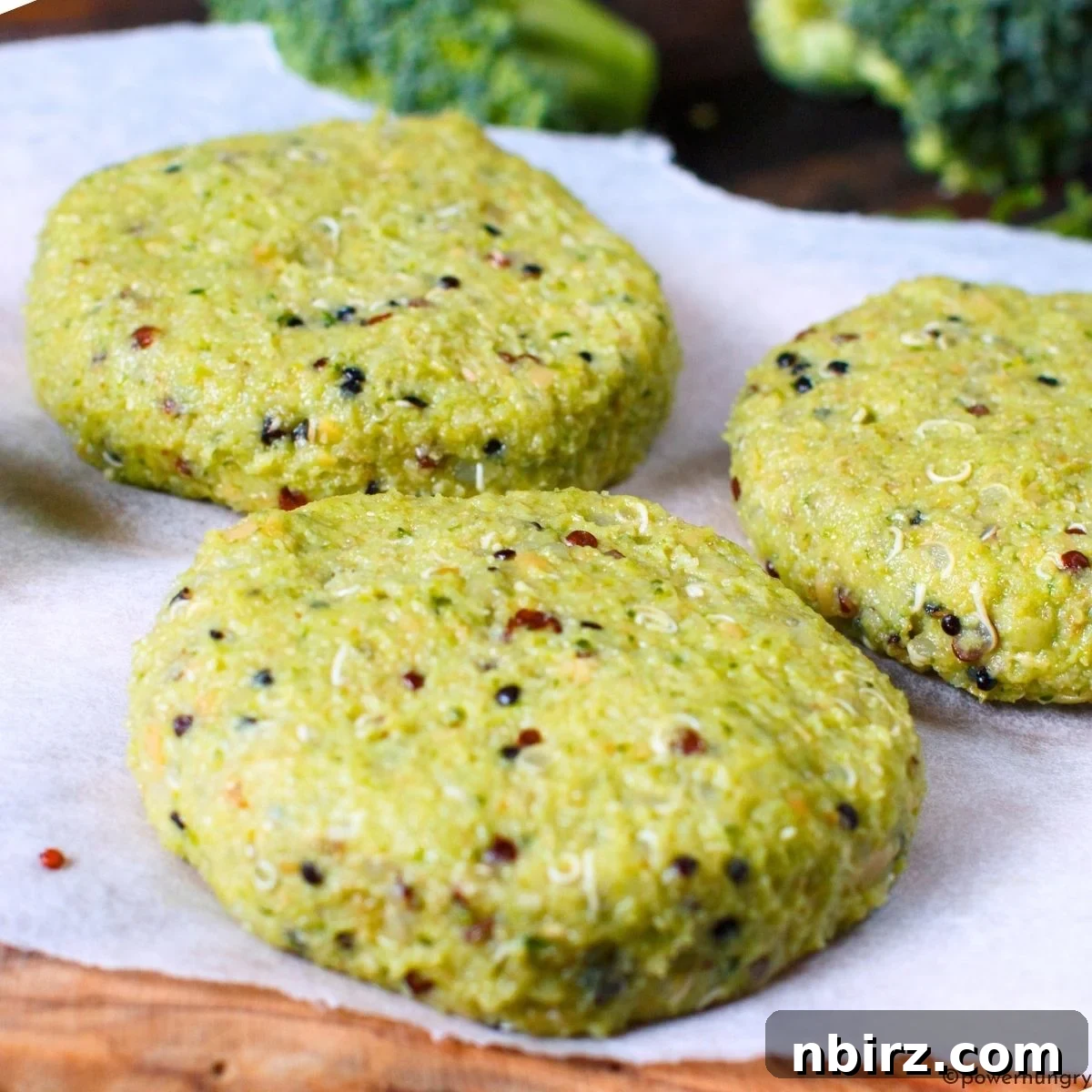 quinoa cakes 3 Unbaked broccoli quinoa cakes neatly arranged on a cutting board, perfectly formed and waiting to be transferred to the oven for baking.