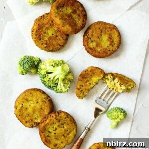 Baked broccoli quinoa cakes on white parchment paper, presented beautifully.