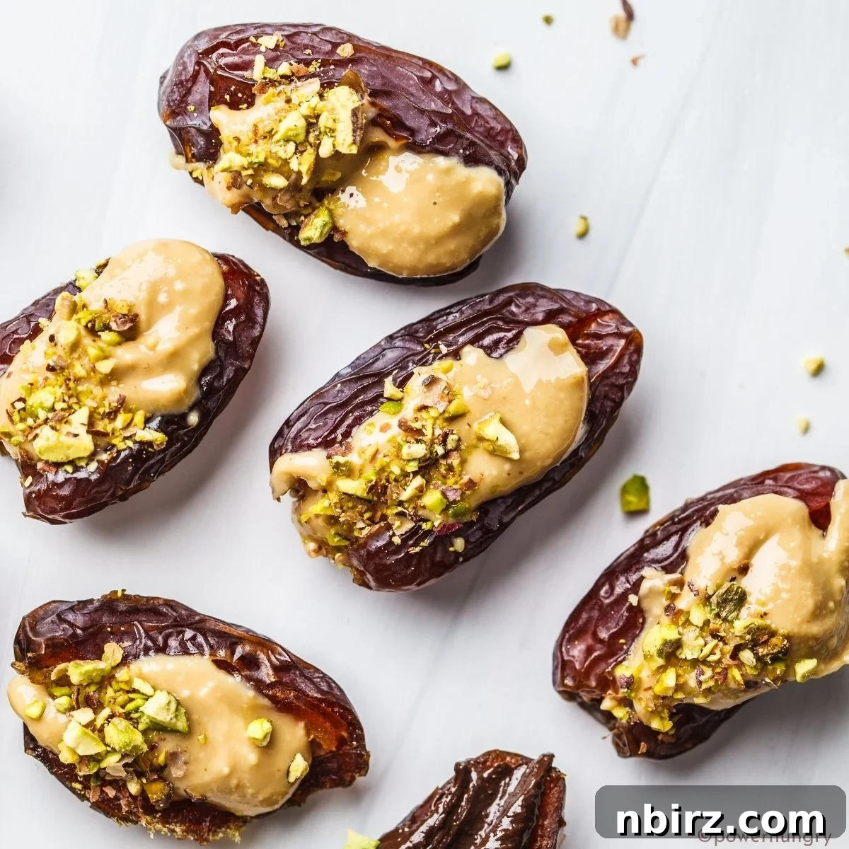 Easy 2-Ingredient Almond Butter Stuffed Dates 4 almond butter stuffed dates topped with chopped pistachios