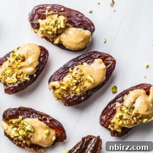almond butter stuffed dates topped with chopped pistachios