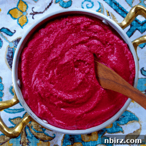 4-Ingredient Beet Hummus in a bowl, garnished.