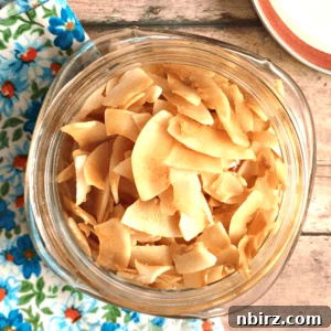 Baked sweet salty coconut chips in a glass jar