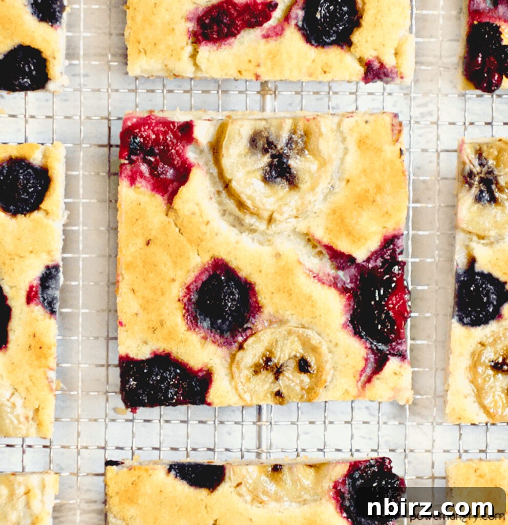 Close-Up of Berry Banana Pancake Close-up shot of a single vegan berry and banana baked pancake square, showcasing its texture and fruit inclusions.