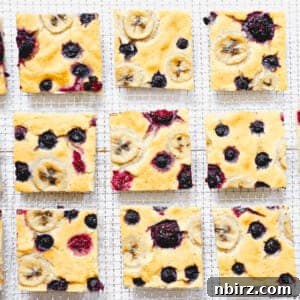 squares of vegan baked pancake with berries on a cooling rack